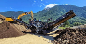 Spaleck's Mobile Screening Machine in Action at a Metal Recycling Facility Against a Beautiful Backdrop