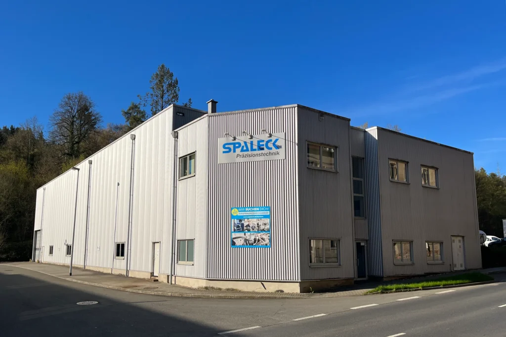 Gebäude der Spaleck Präzisionstechnik GmbH & Co. KG mit Firmenlogo an der Fassade.